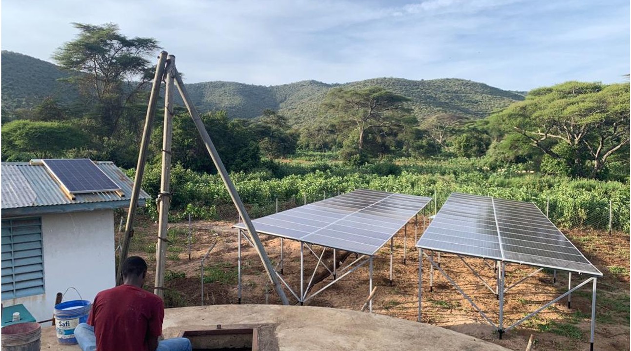 Ground-mounted solar array powering a borehole pump in rural Tanzania